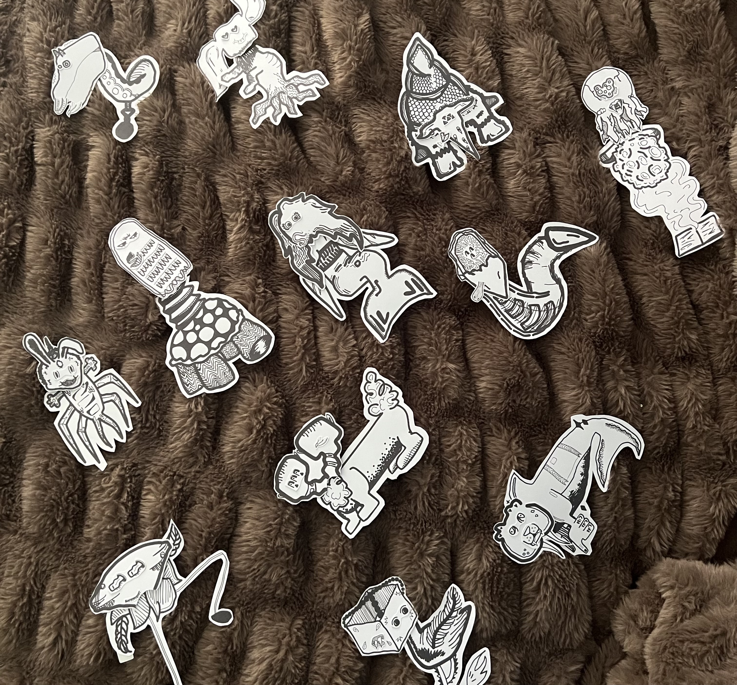 Black and white monster stickers laid on a brown fuzzy blanket
